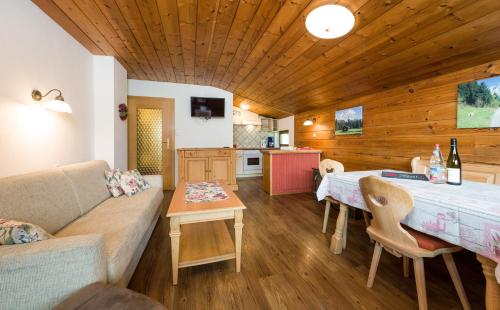 a living room with a couch and a table at Tyrol Appartements in Ehrwald