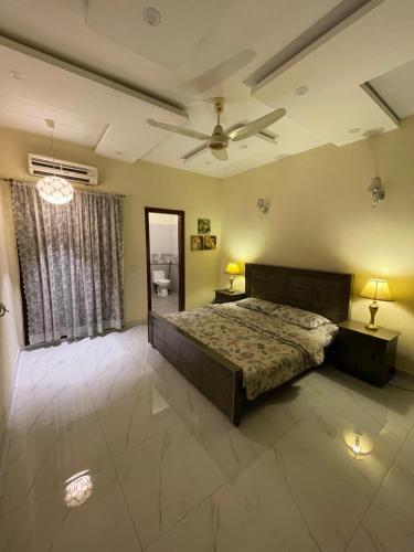 a bedroom with a bed and a ceiling fan at Lovely 1-Bed House in Lahore in Lahore