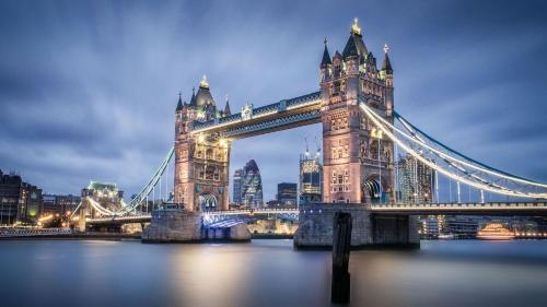 a suspension bridge over the water at night at City Living apartments in London