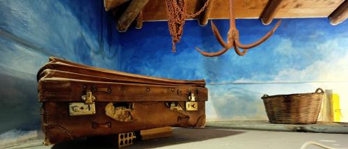 a room with a suitcase and a blue wall at Archontiko Art Hotel in Galaxidhion