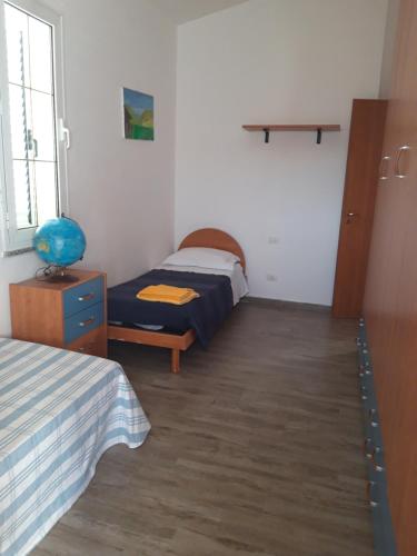 a bedroom with a bed and a nightstand and a bed and a window at Sole e relax in Pula