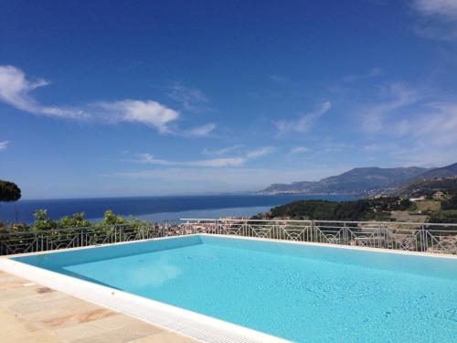 a swimming pool with a view of the ocean at Villa Gaia - Luxury Villa, pool & wellness rooms in Bordighera