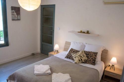une chambre avec un lit avec des oreillers dessus dans l'établissement La maison de Papé, à Arles
