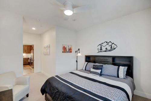 a bedroom with a large bed and a chair at New Luxury Loft #107 With Huge Hot Tub & Great Views - 500 Dollars Of FREE Activities & Equipment Rentals Daily in Winter Park