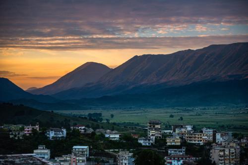 a view of a city with mountains in the background at Guesthouse Mele in Gjirokastër