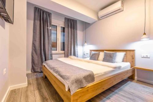 a bedroom with a large bed and a window at Apartment Dudanovski City Center - Apartment No. 4 in Ohrid