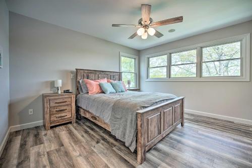 a bedroom with a bed and a ceiling fan at Pet-Friendly Grass Lake Retreat with Game Room! in Grass Lake