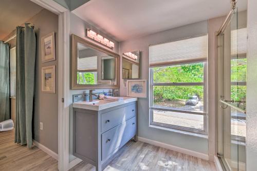 a bathroom with a sink and a large window at Canal-front Gem with Pool and Hot Tub in Anna Maria in Anna Maria