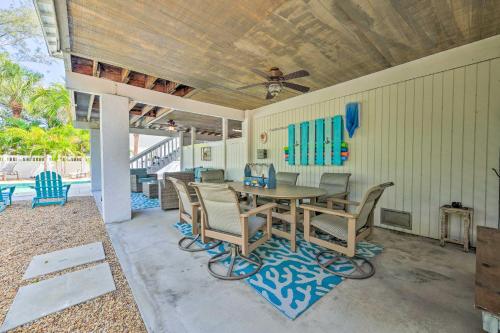 a patio with a table and chairs and a ceiling at Canal-front Gem with Pool and Hot Tub in Anna Maria in Anna Maria