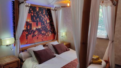 1 dormitorio con 1 cama y una pintura en la pared en coucher de soleil vensac ocean Montalivet, en Vensac