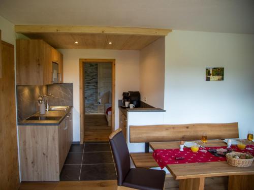 a kitchen and dining room with a table and a dining room at Ramslerhof - Chiemgau Karte in Inzell