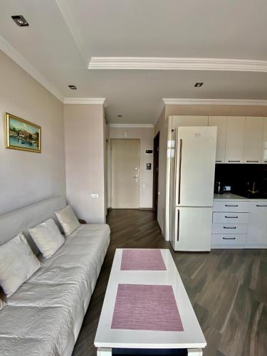 a living room with a couch and a kitchen at Villa Old Batumi in Batumi