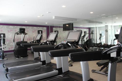a gym with treadmills and elliptical machines at Crowne Plaza Leon, an IHG Hotel in León