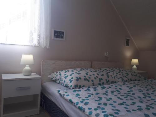 A bed or beds in a room at Locher Apartman 2 Bükfürdő