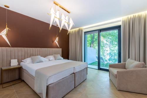 a bedroom with a large bed and a couch at Bošket Luxury Rooms in Split