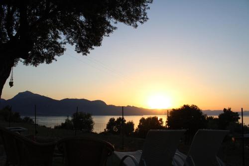 a view of the sun setting over the water at Daphné Village House - close to Methana & Poros in Methana