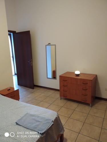 a bedroom with a dresser and a mirror at Mamma Giulia in Stroncone