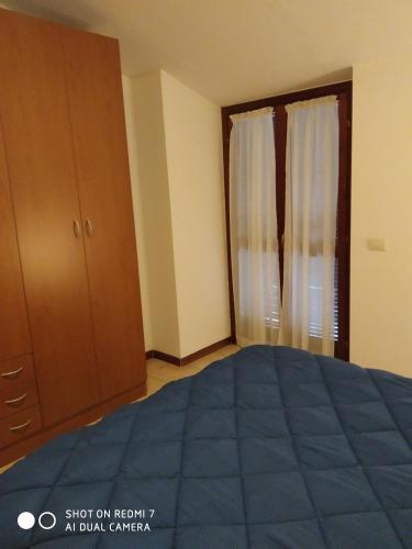 a bedroom with a blue bed and a closet at Mamma Giulia in Stroncone