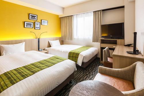 Ένα ή περισσότερα κρεβάτια σε δωμάτιο στο Smile Hotel Tokyo Asagaya