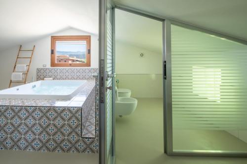 a bathroom with a tub and a sink and a toilet at Hotel Nice in Sorrento