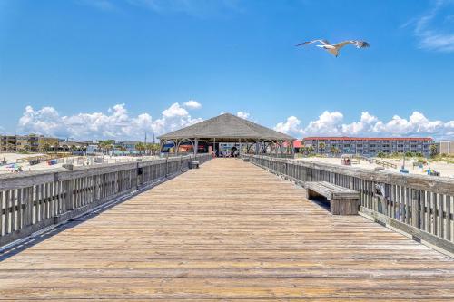 a wooden pier with a gazebo on the beach at Carbo House Eleven in Tybee Island