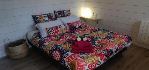 a bedroom with a bed with a colorful blanket at Gite La Basse-Cour in Cordemais