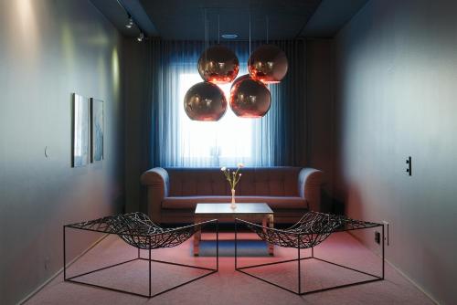 a living room with a couch and a table and two chairs at Best Western Princess Hotel in Norrköping