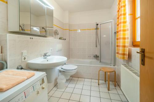 a bathroom with a sink and a toilet and a shower at Ferienpark Freesenbruch Wohnung 3 1 - Schöne Auszeit in Zingst
