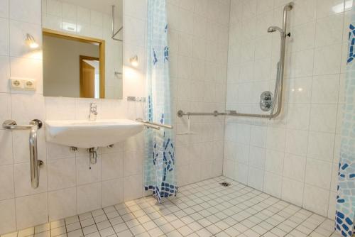 a bathroom with a sink and a shower at Nautilus in Zingst