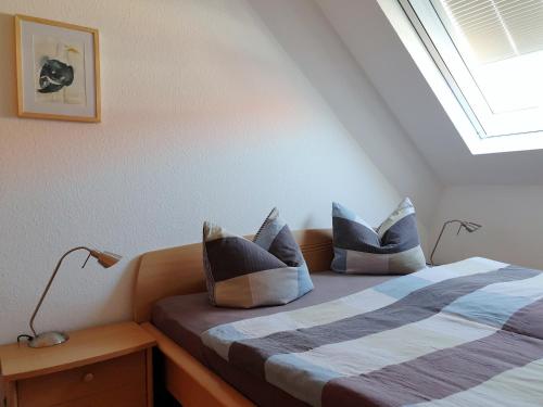 a bedroom with a bed with blue and white pillows at Residenz am Strand Wohnung 2-40 in Zingst