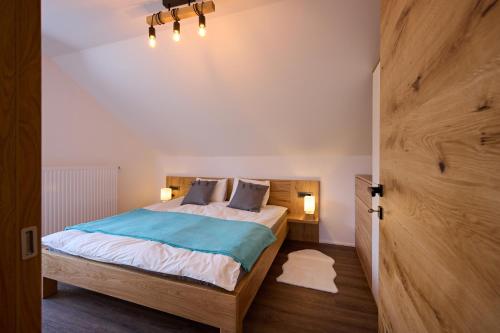 a bedroom with a bed and two pillows on it at Domačija Metul in Luče