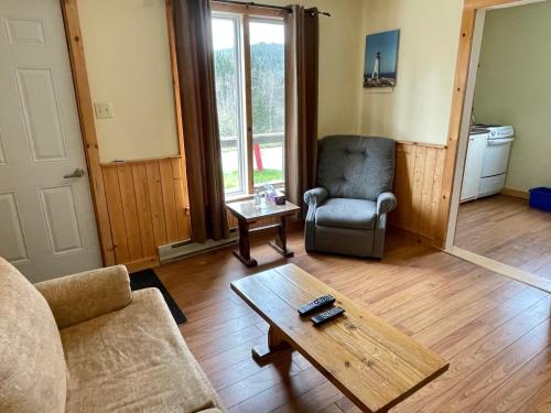 a living room with a couch and a coffee table at Bonne Bay Cottages in Bonne Bay Pond
