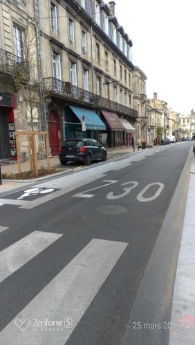 an empty city street with a car parked on the road at Studio en Duplex-Aircon-Terrasse-Parking-Calme in Bordeaux