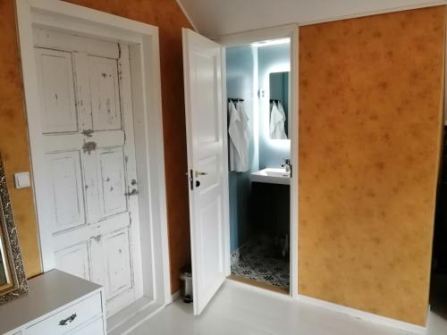 uma casa de banho com um espelho e um lavatório em Guesthouse Lokinlaulu em Kotka