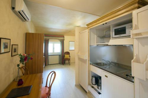 a kitchen and dining room with a table in a room at Park Hotel Villa Salzea in Trofarello