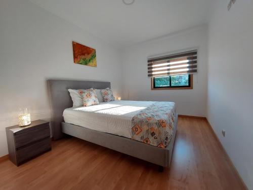 a bedroom with a large bed and a window at Vitoria Douro in Vila Nova de Gaia