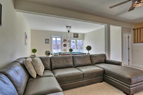 a living room with a brown leather couch at New ! Slopeside Townhome : WFH, Ski, Dine & Hike in Tannersville
