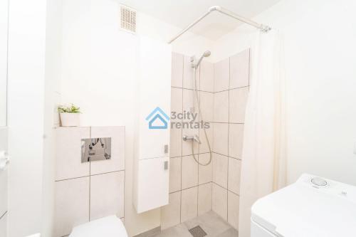 a bathroom with a shower and a toilet at Mini Apartment Sopot in Sopot