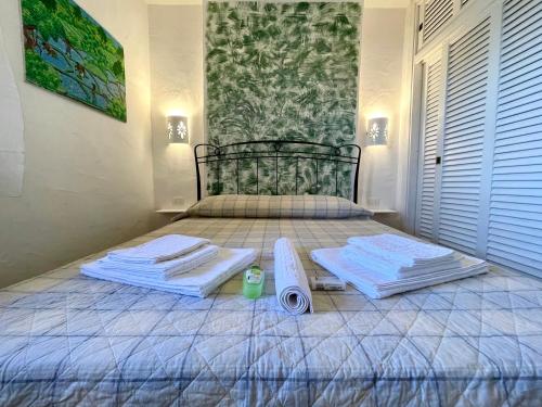 a bedroom with a bed with towels on it at SAN TEODORO PUNTA EST GIARDINO VISTA MARe in Capo Coda Cavallo