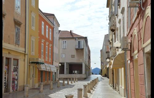 an empty street in a city with buildings at Diadora in Zadar