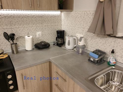 a kitchen counter top with appliances on it at blue - comfy center rodos in Asgourou