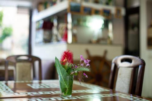 a vase of flowers sitting on a table at Saki Apartments in Budva