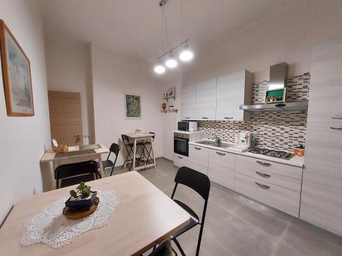 a kitchen with a table and a dining room at B&B Petra Hercules in Torre Annunziata