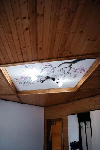 a light on a ceiling with a painting on it at Котедж з неймовірними краєвидами, Карпатський Чан DREAM, Чан Джакузі in Slavske