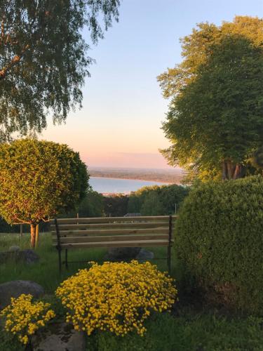 a park bench with a view of the water at Villa med fantastisk utsikt in Båstad