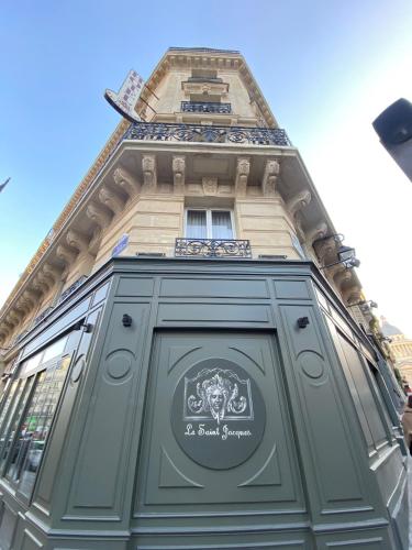 a building with a green door with a sign on it at Hotel & Spa Saint-Jacques in Paris