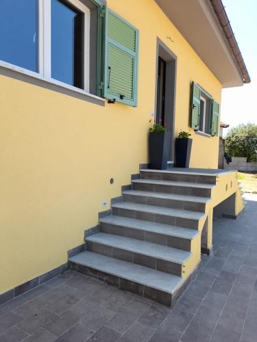 a set of stairs in front of a yellow building at Atena in La Spezia