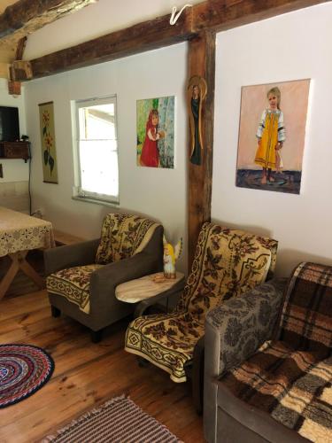 a living room with two chairs and a couch at Chatka in Wajków