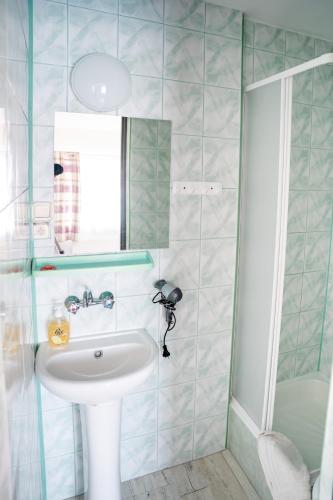 a bathroom with a sink and a shower at Marinas Rewa in Rewa