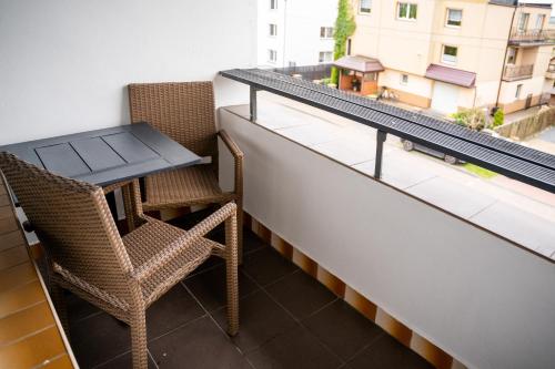 a balcony with a table and two chairs and a table at Marinas Rewa in Rewa